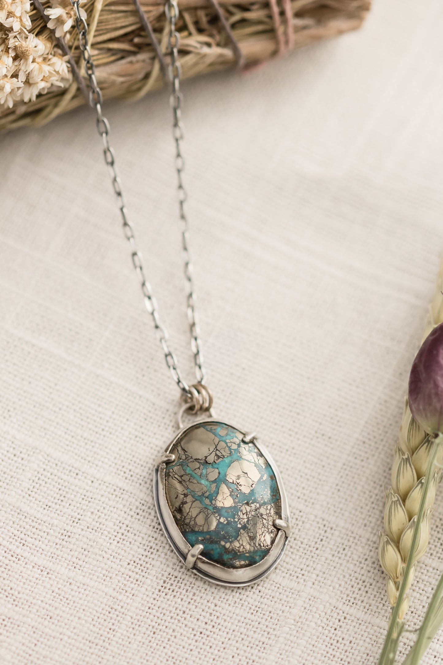 Morenci II turquoise pendant necklace on linen background with dried flowers