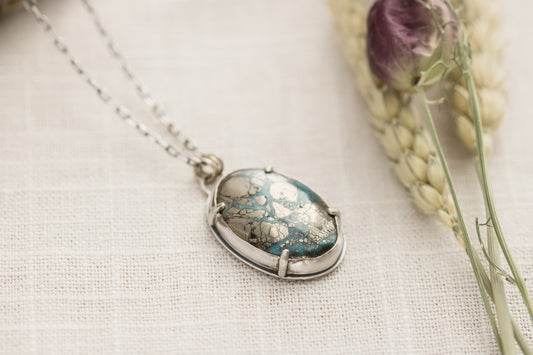 Morenci II turquoise pendant necklace on linen background with dried flowers