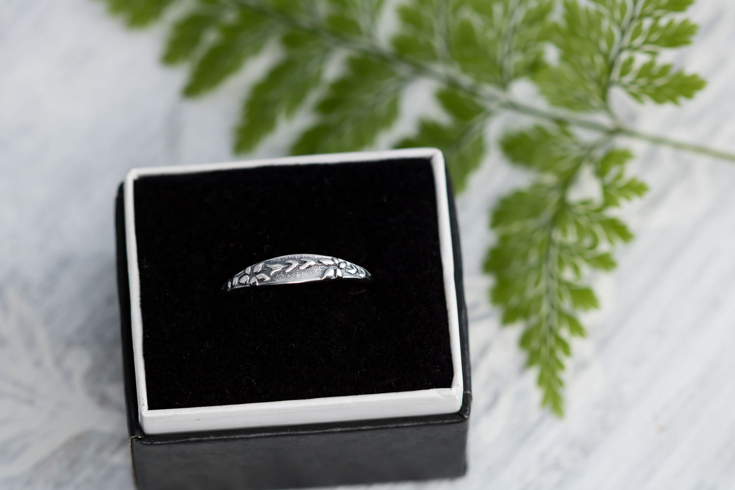 Petite sterling silver leaf ring in black box, vintage design.
