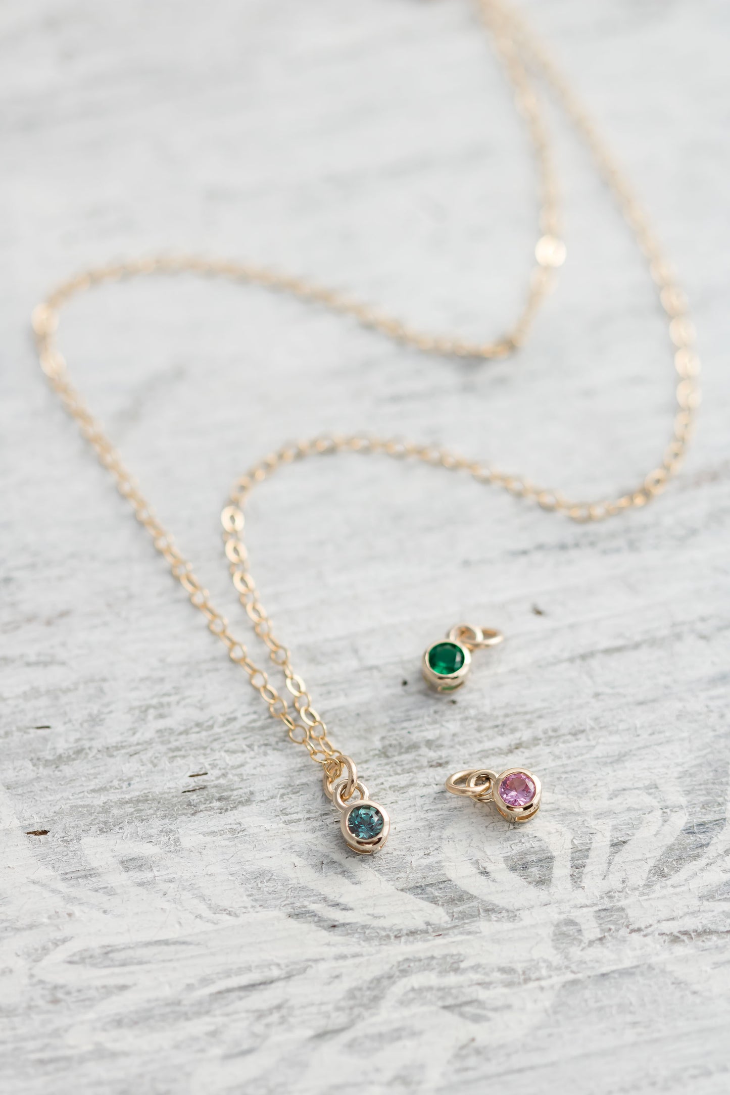 Solid yellow 14k Gold birthstone charms on solid yellow gold chain.