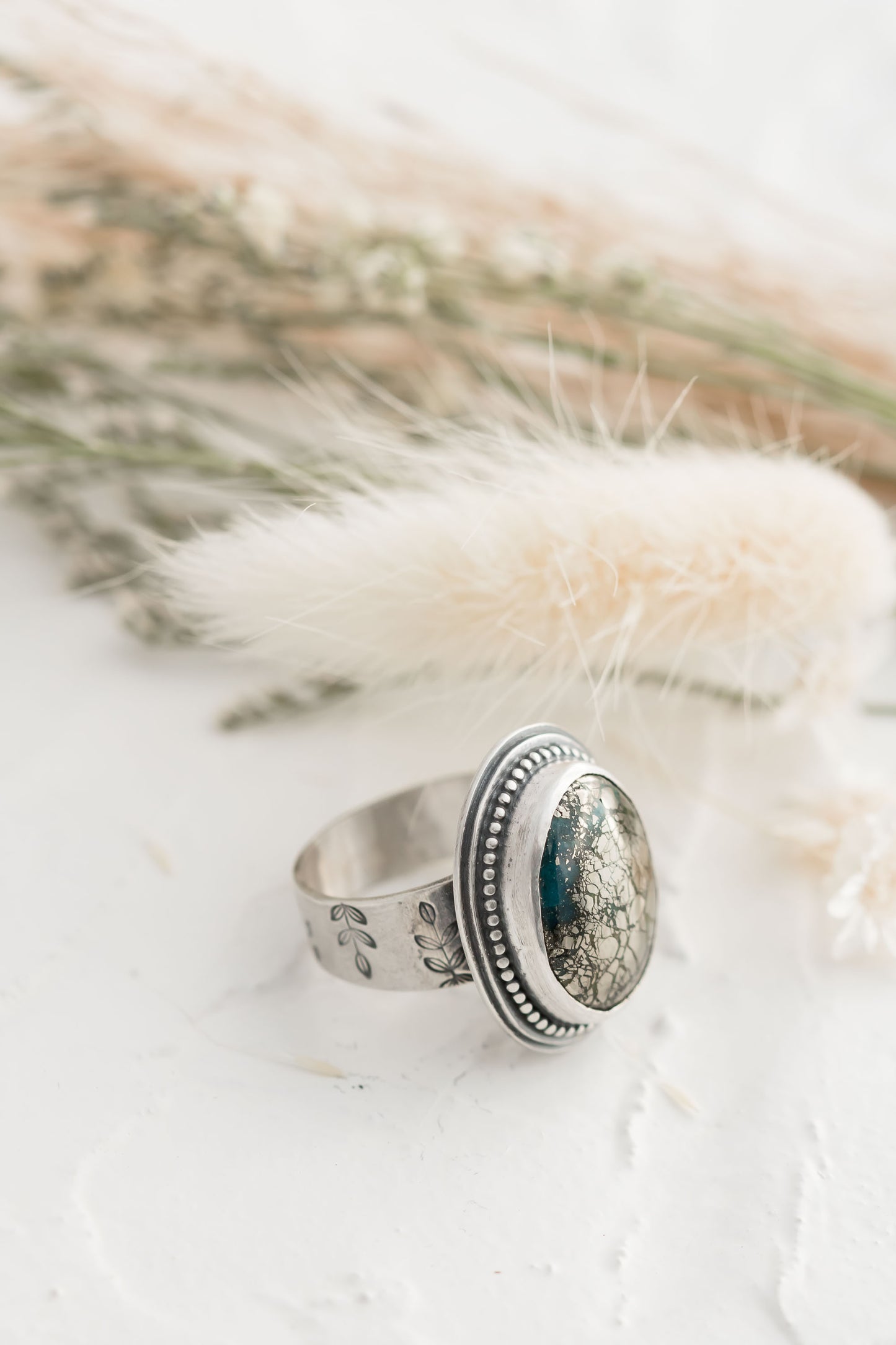 Sterling silver and morinci #2 Turquoise and pyrite ring with a stamped floral band.