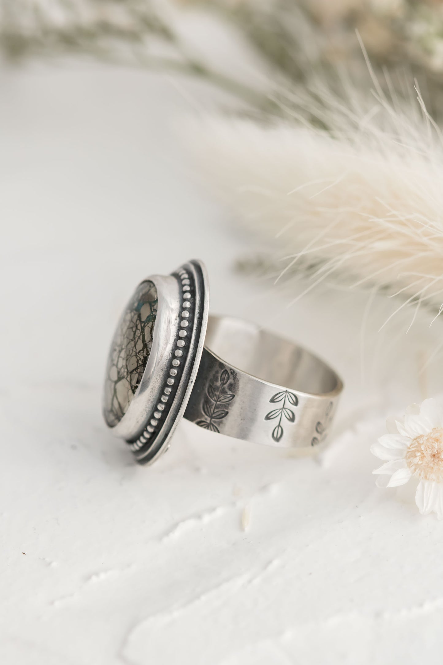 Sterling silver and morinci #2 Turquoise and pyrite ring with a stamped floral band.