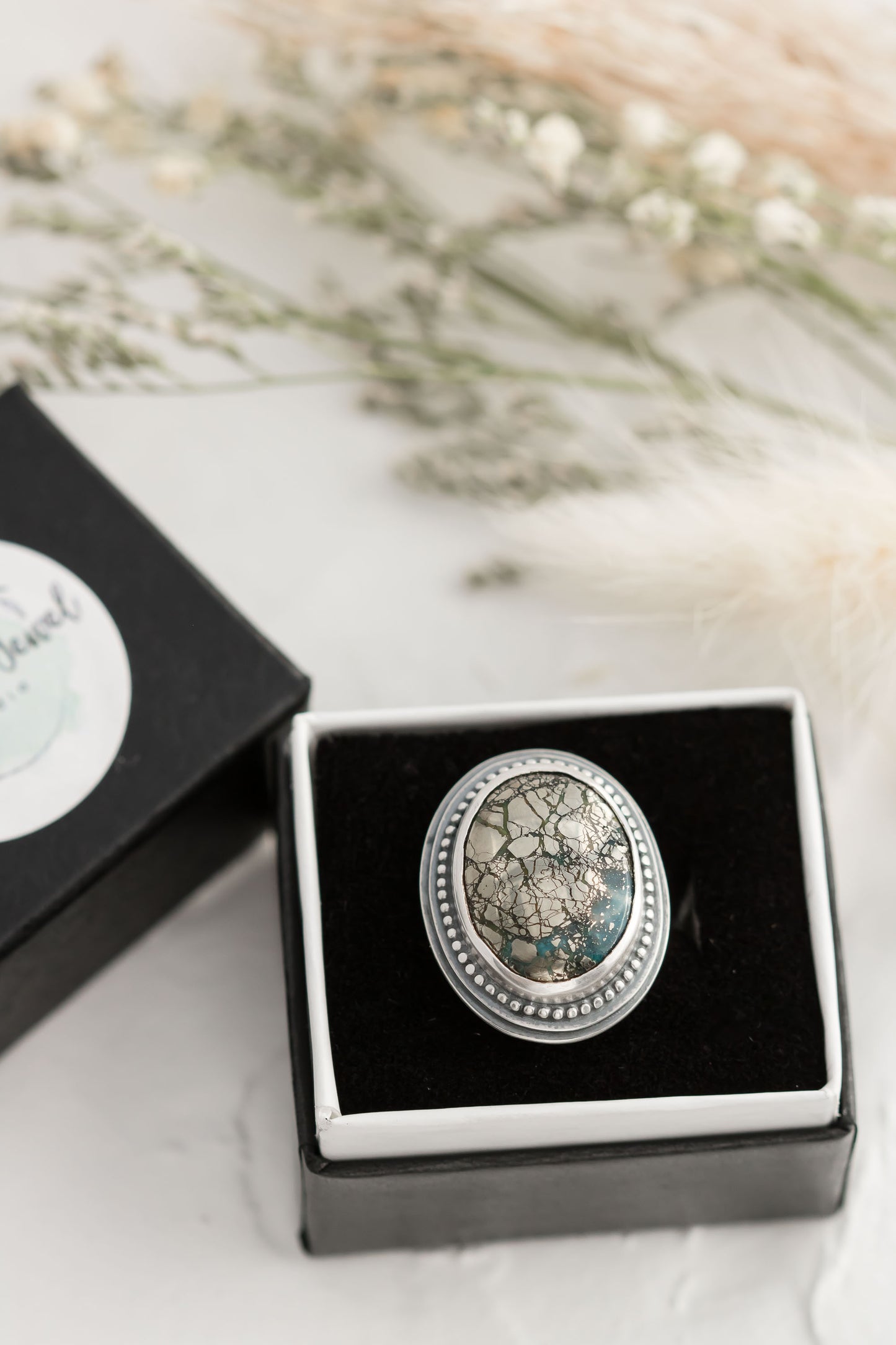 Sterling silver and morinci #2 Turquoise and pyrite ring with a stamped floral band.