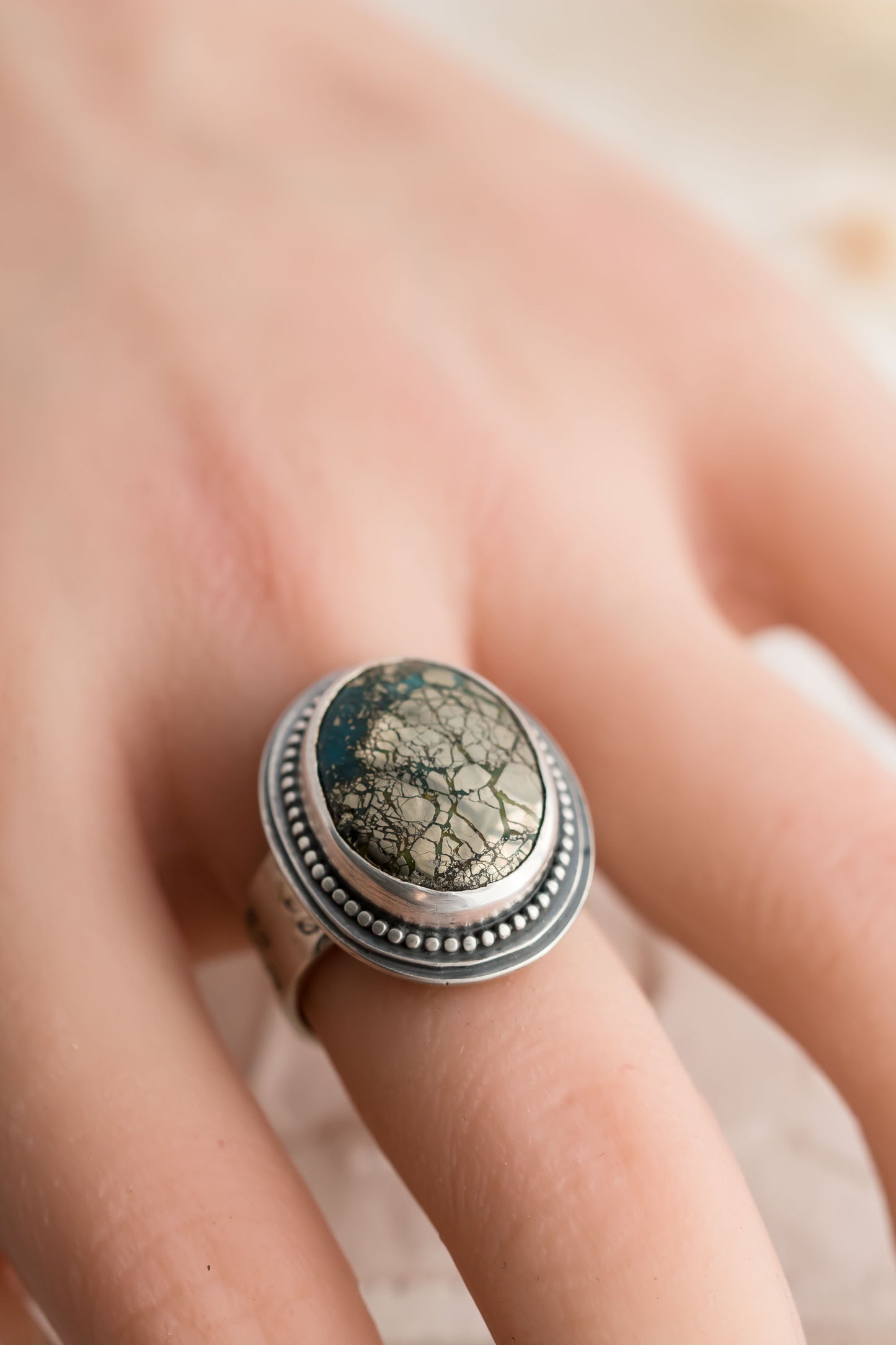 Sterling silver and morinci #2 Turquoise ring with a stamped floral band.