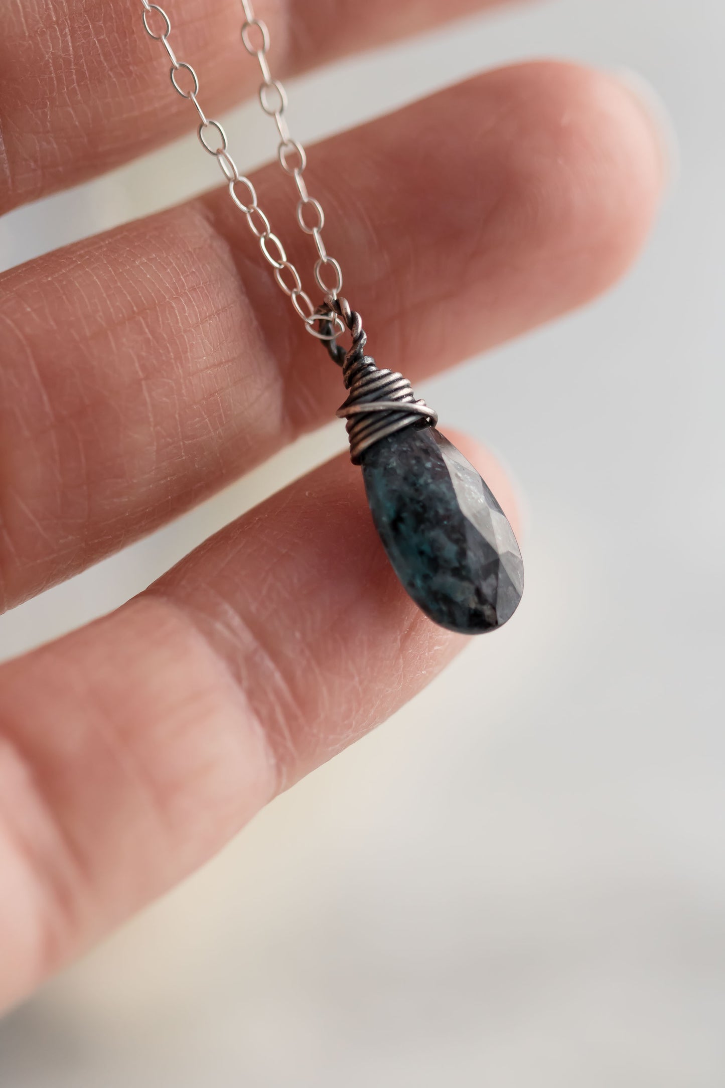 Sterling silver wire wrapped teal moss kyanite briolette gemstone hanging from sterling silver chain.