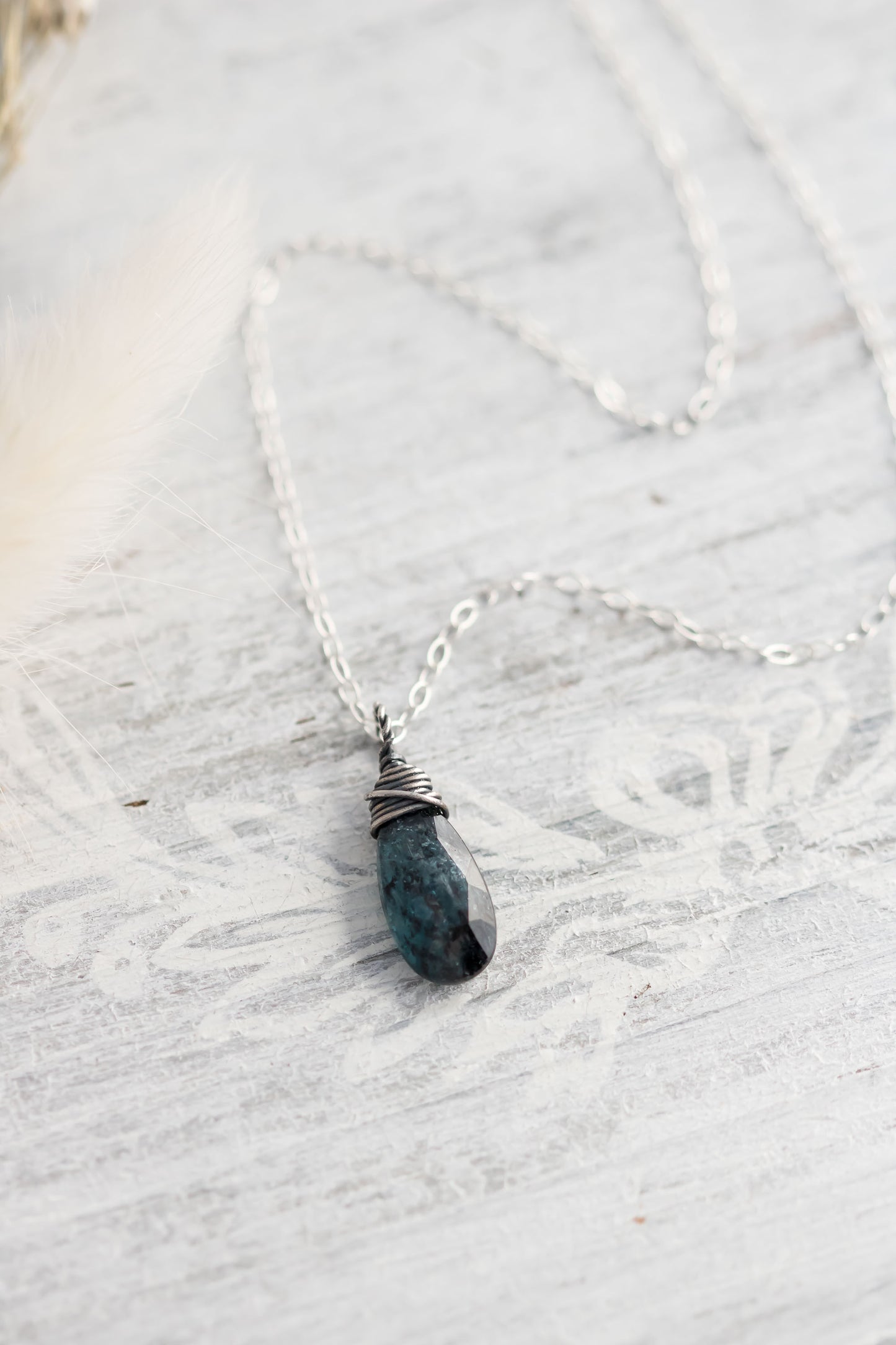 Sterling silver wire wrapped teal moss kyanite briolette gemstone hanging from sterling silver chain.