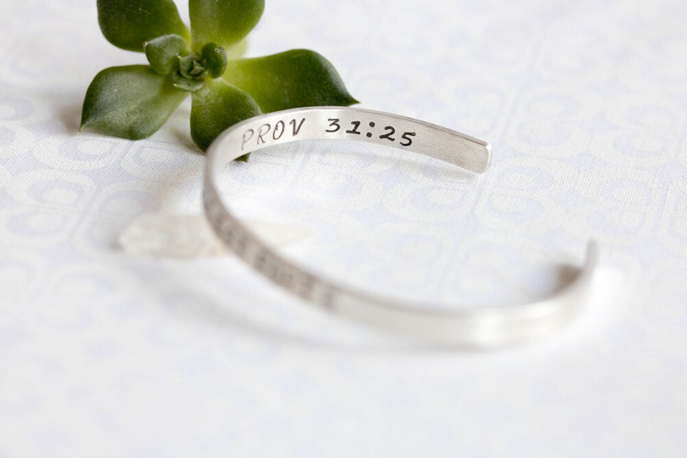 Sterling silver cuff bracelet stamped with Elle Est Forte and Prov 31:25.