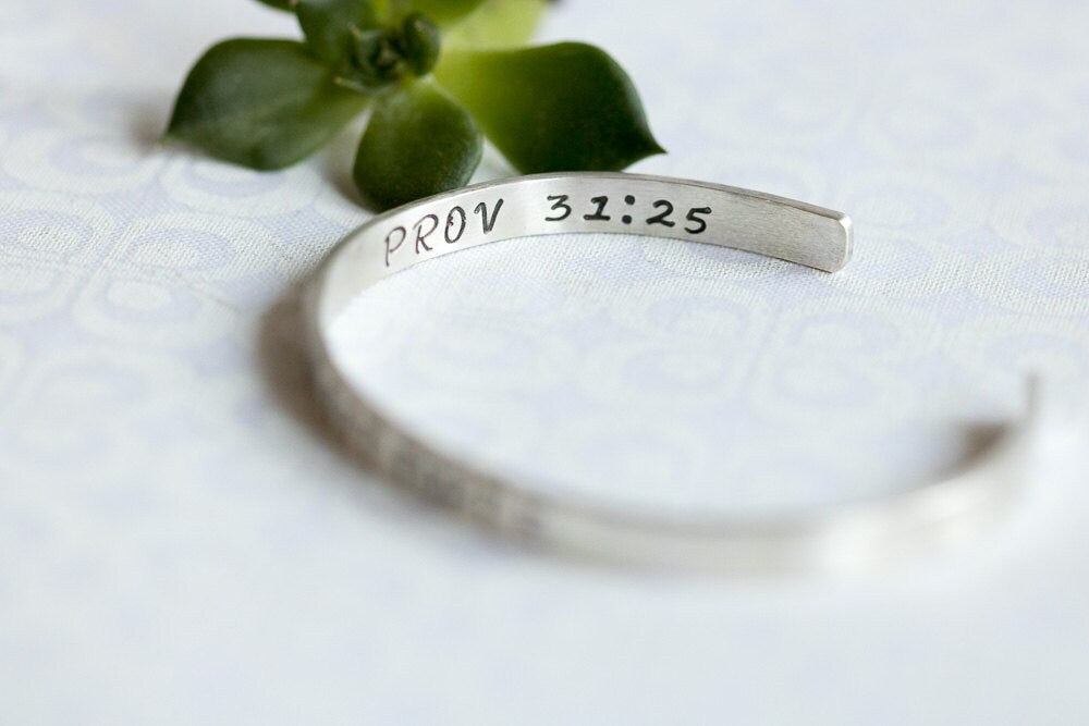 Sterling silver cuff bracelet stamped with Elle Est Forte and Prov 31:25.