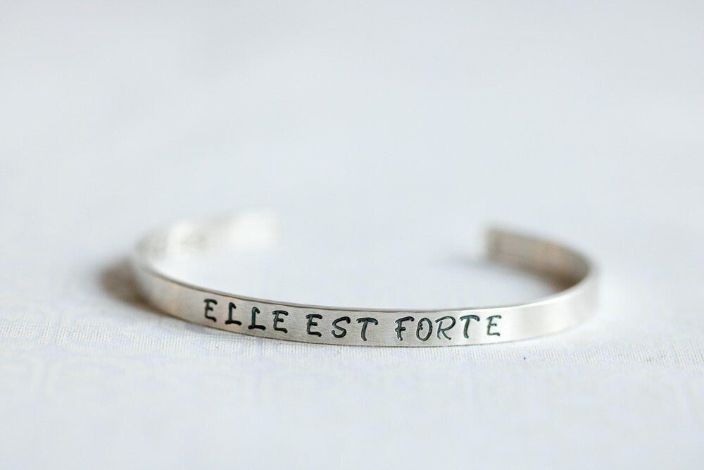 Sterling silver cuff bracelet stamped with Elle Est Forte and Prov 31:25.