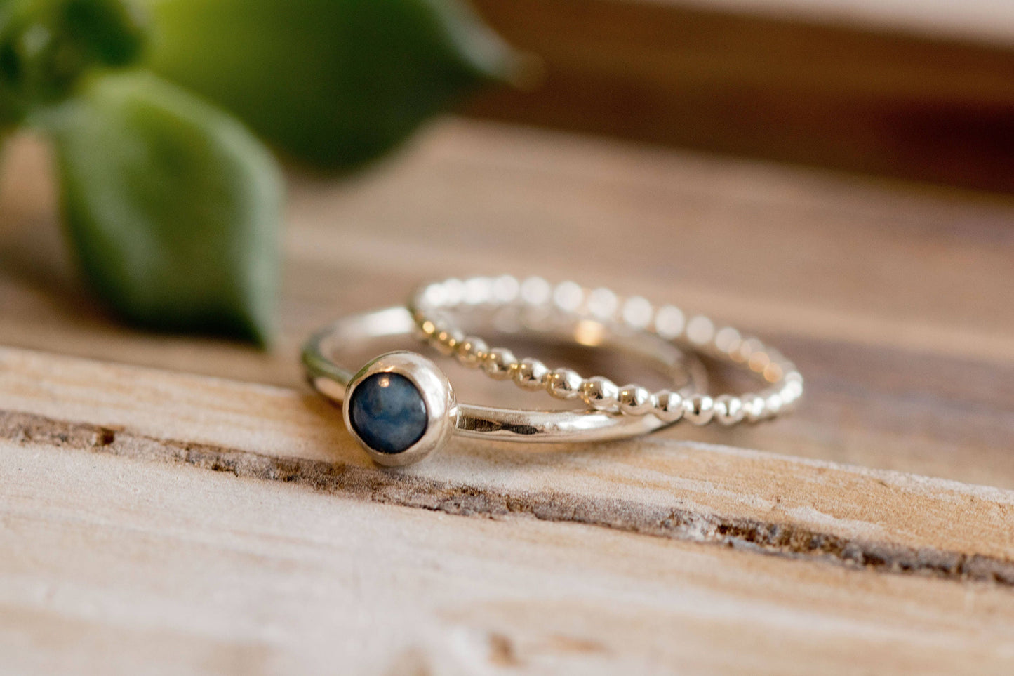 Denim lapis ring with beaded silver band on a wooden surface, showcasing eco-friendly craftsmanship.