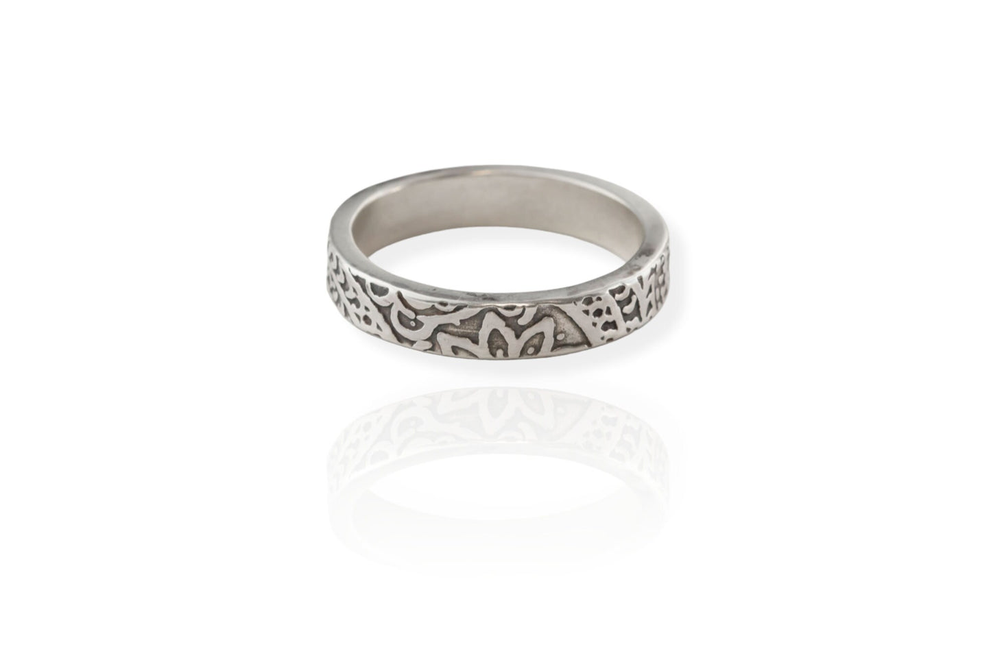 Detailed view of a sterling silver floral textured ring on a white background, emphasizing the unique pattern.