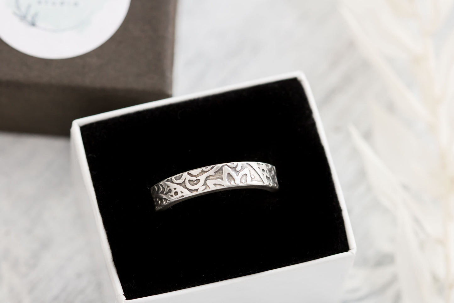 terling silver floral textured ring displayed in an elegant black and white ring box, highlighting its gift-ready packaging.
