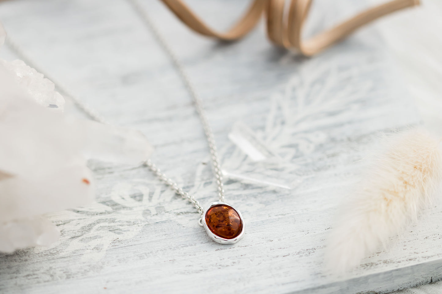 Baltic Amber oval cabochon pendant in a hammered sterling silver bezel setting on a sterling silver 18 inch with 2 inch extender rolo chain.