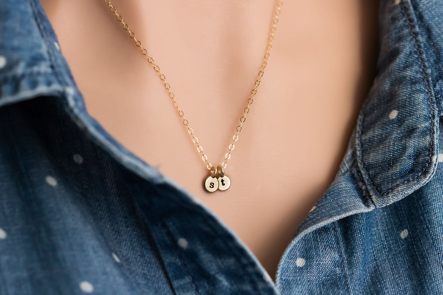 solid 14k tiny round initial charm on a solid 14k gold chain.