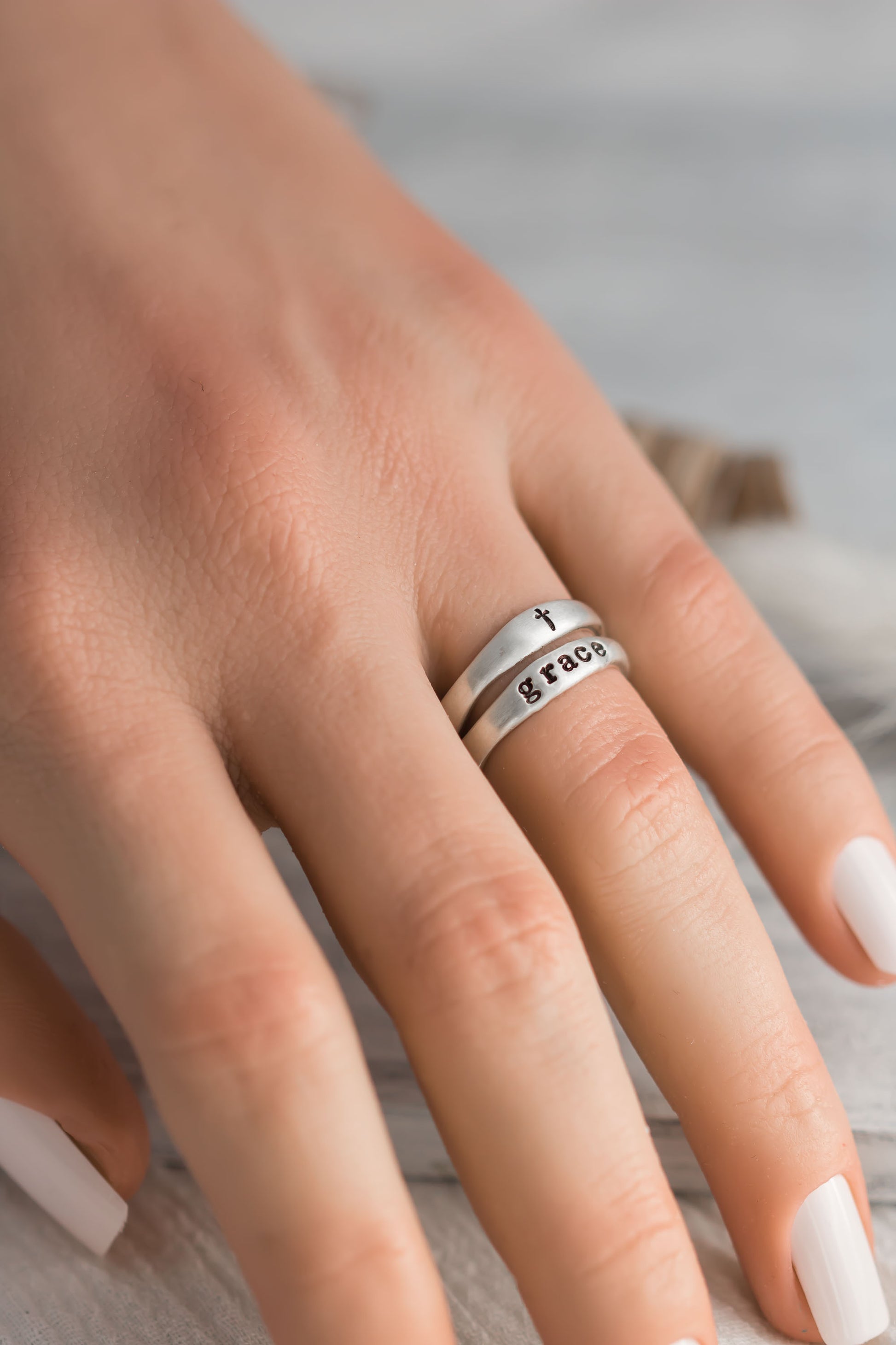 Sterling silver organic free for shape ring set with on ring stamped with the word grace and one with a cross. 