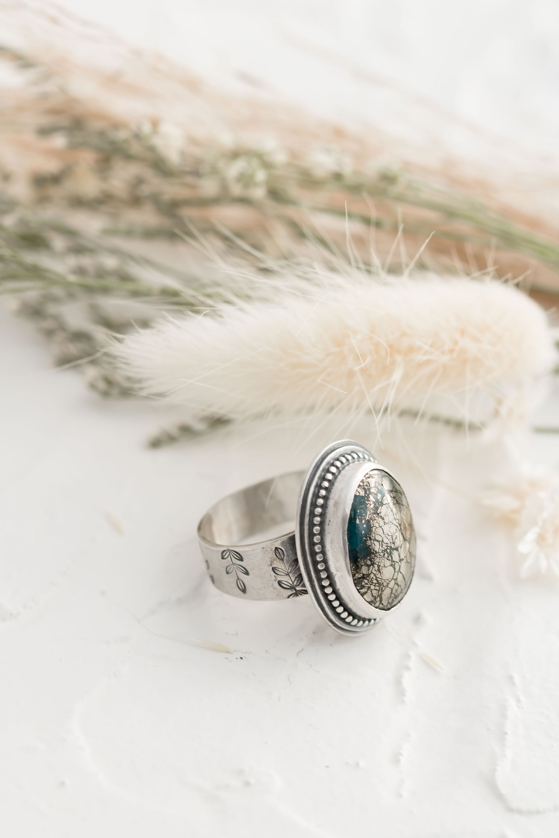 Sterling silver and morinci #2 Turquoise and pyrite ring with a stamped floral band. 