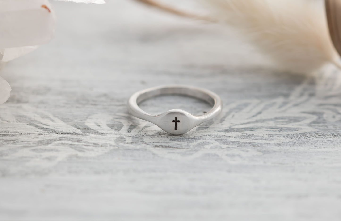 Sterling silver signet ring with a choice of an initial, cross , heart, or paw print. 