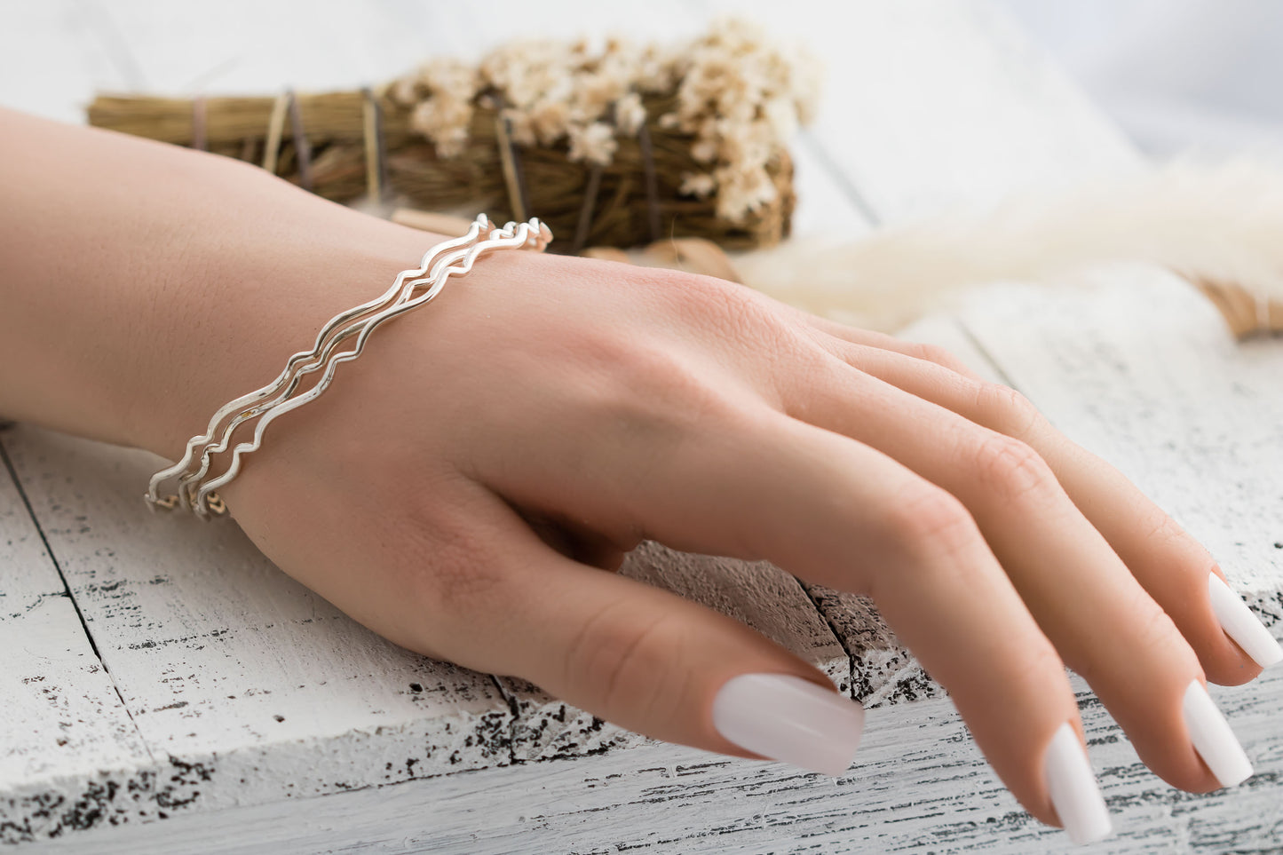 Set of three sterling silver stacking wavy bangle bracelets.