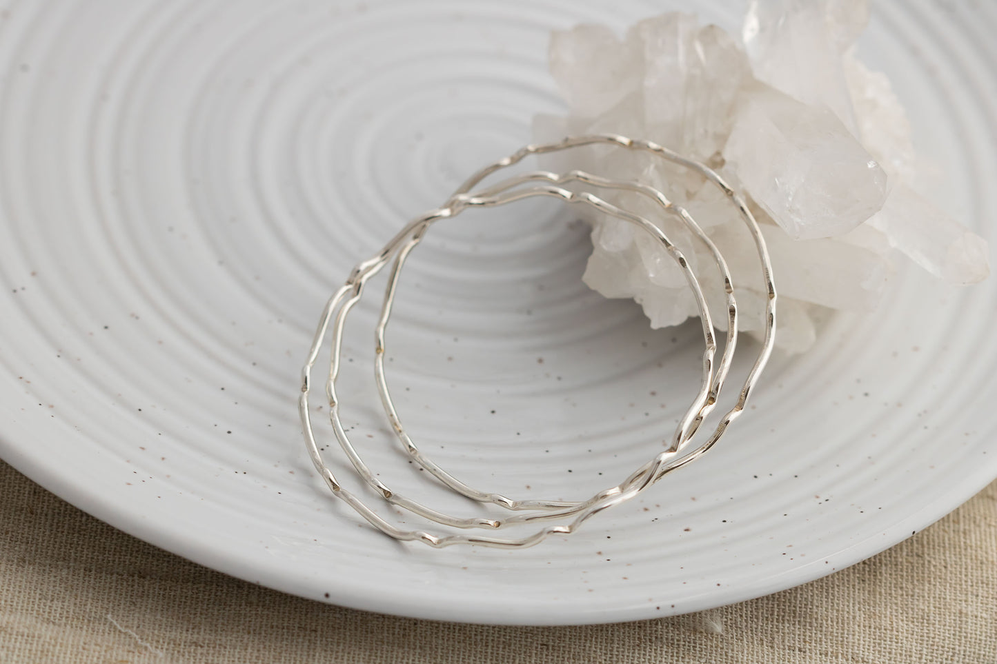 Set of three sterling silver stacking wavy bangle bracelets.