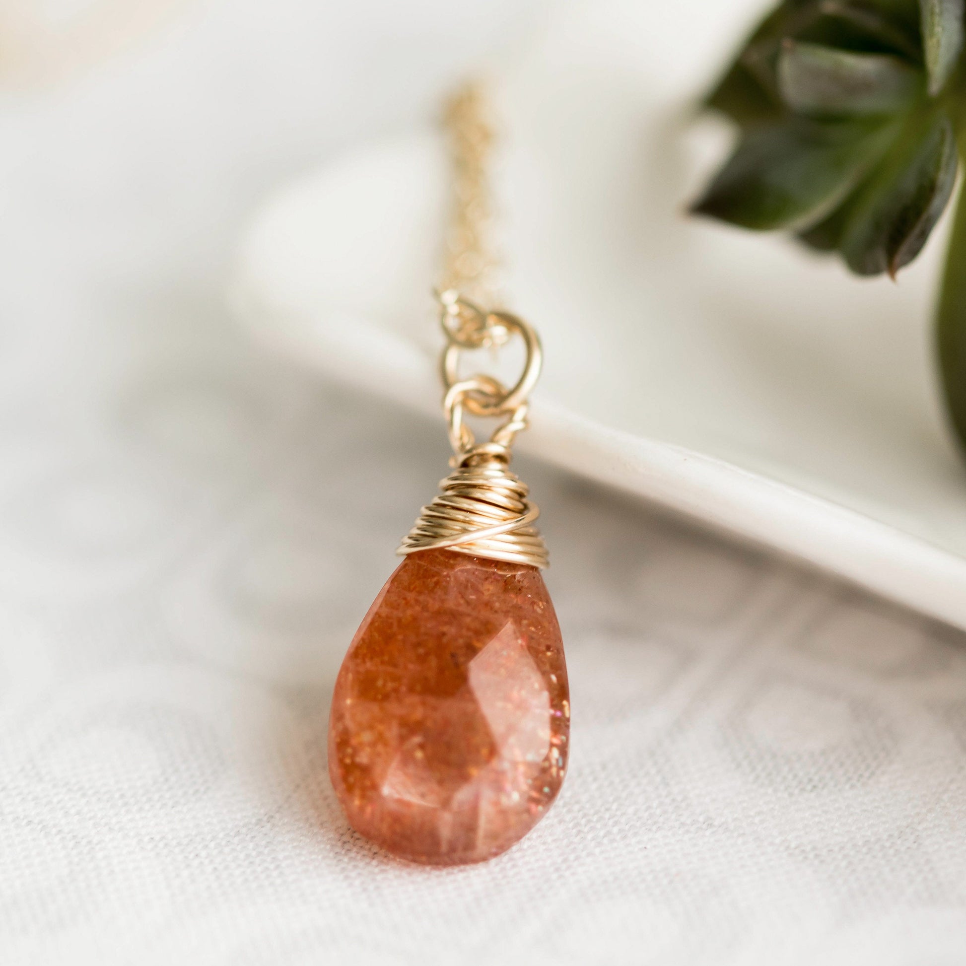 Sunstone pear shaped faceted, briolette wire wrapped in gold filled wire, hanging from gold filled chain. 