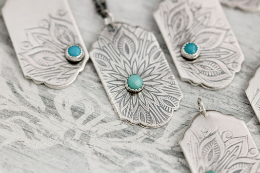 Sterling silver tag necklace with mandala design and a genuine turquoise cabochon. 