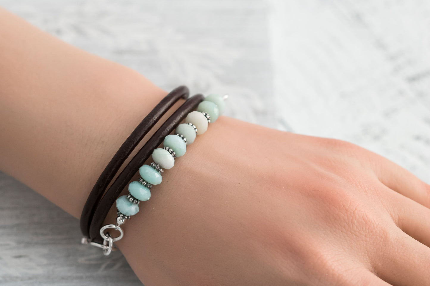 Triple wrap leather cord bracelet made with aqua blue amazonite beads sterling silver accents, and a handcrafted sterling silver hook clasp.